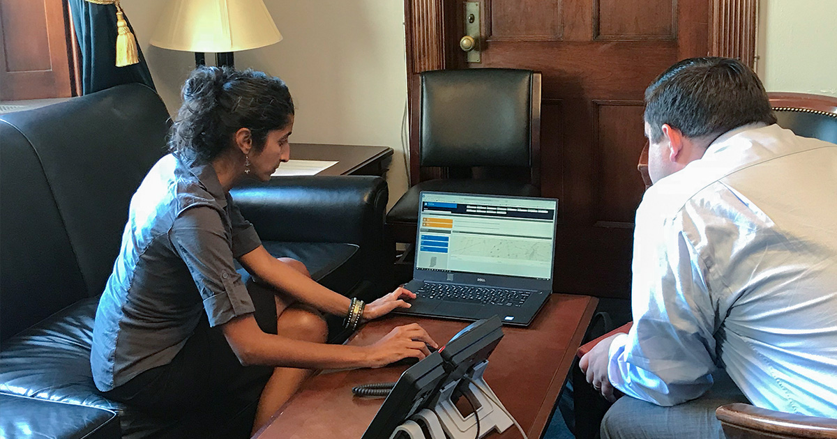 Senior Statistician Aparna Keshaviah provides a demo of the S.T.Op NextGen Dashboard to Senior congressional staff.