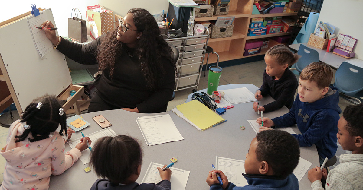 A teacher engages her students in a class lesson.